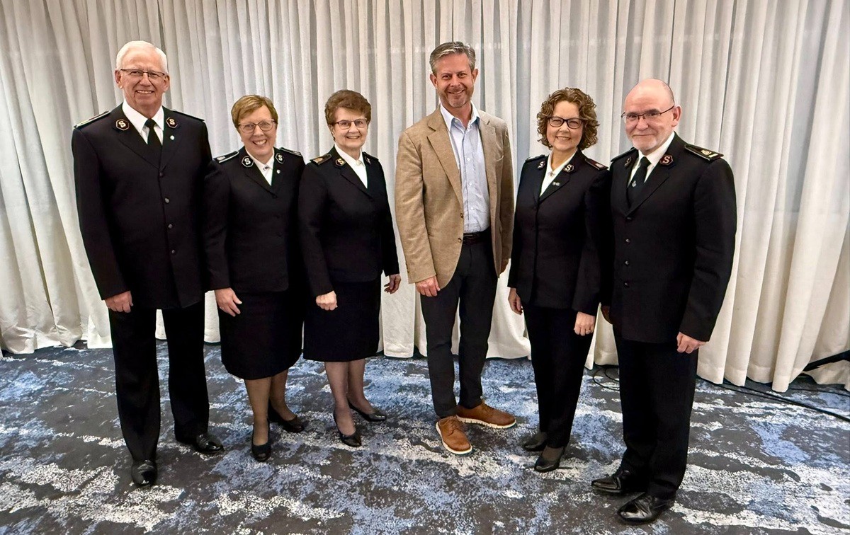 A group of people standing and smiling