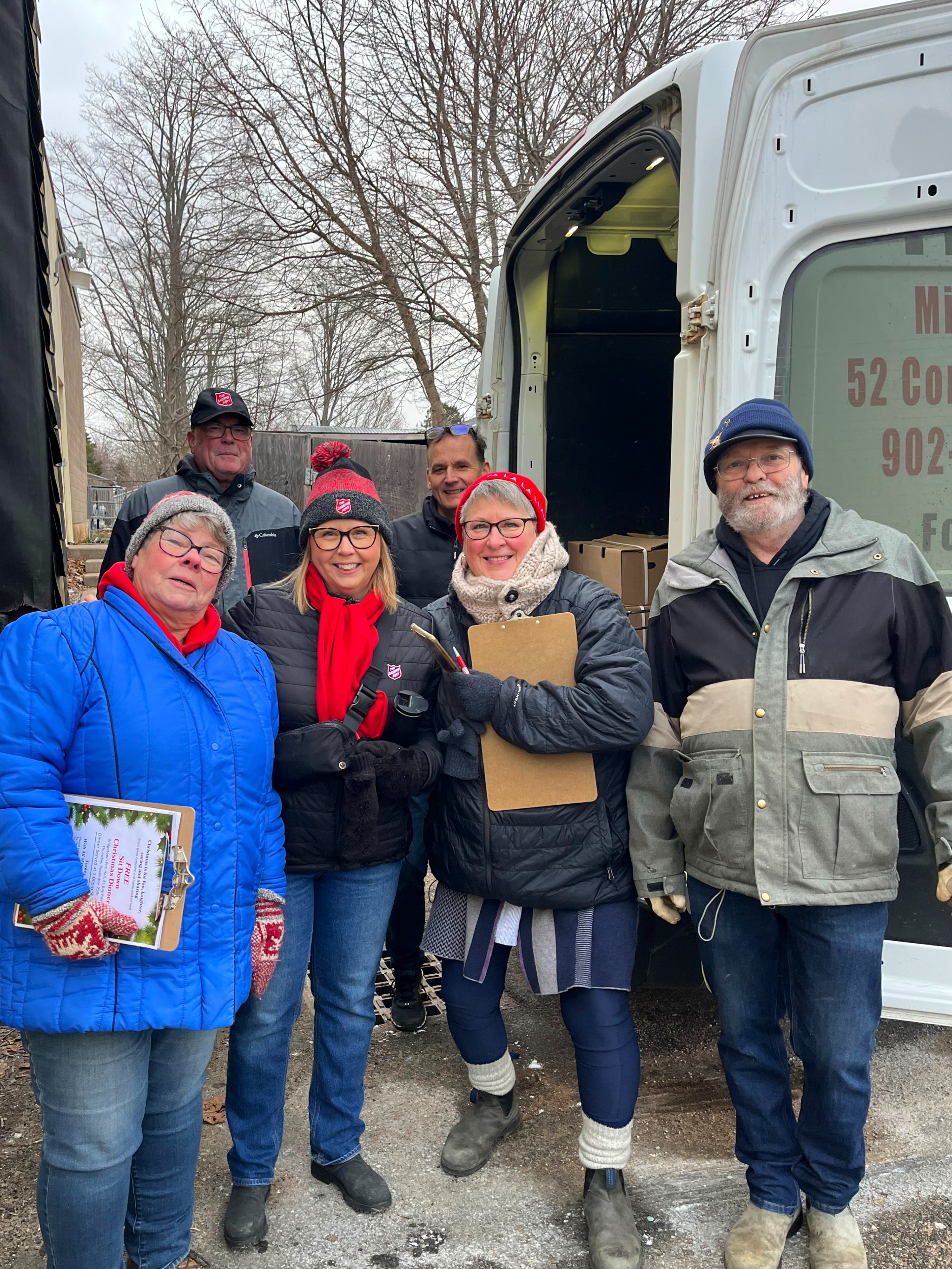 Volunteers stand outside of a Salvation Army truck