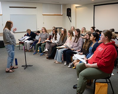 A woman leads a choir