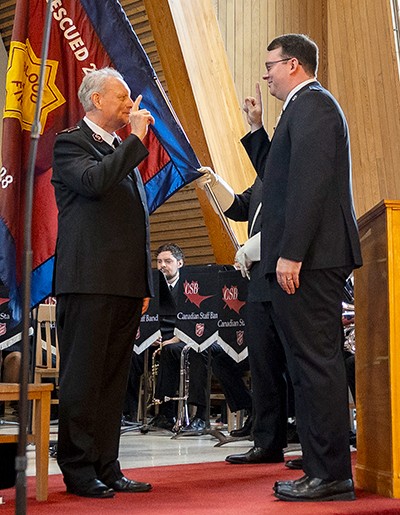 Two men salute each other
