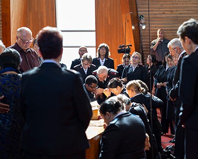 A group of people gather in prayer