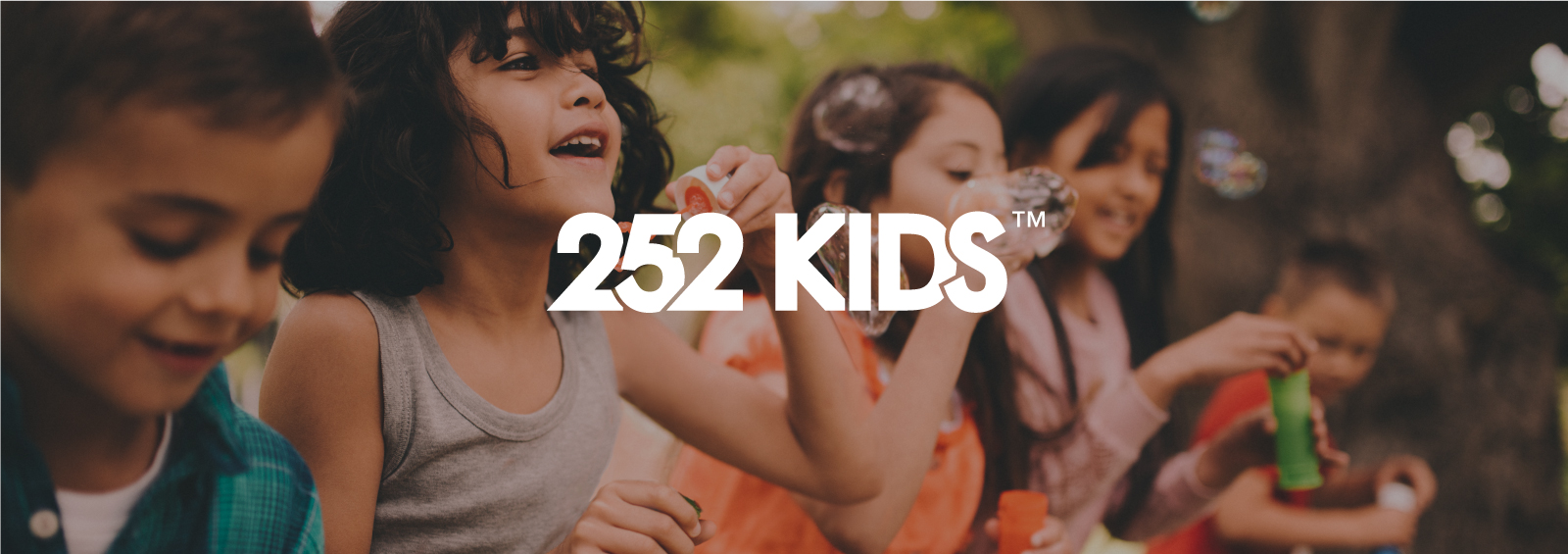 252 Kids logo, with 5 children happily playing with bubbles in the background