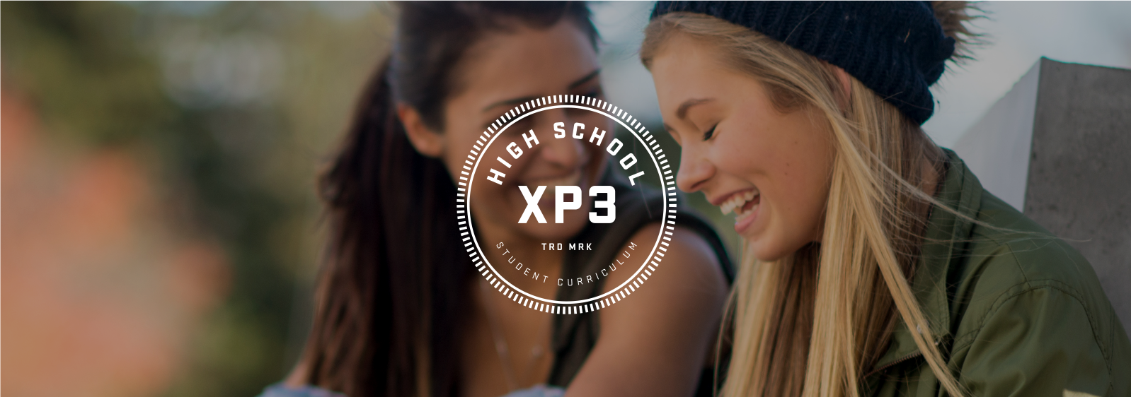 XP3 High School Curriculum logo, with two girls laughing in the background