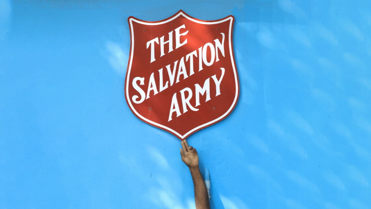 image of a hand pointing to Salvation Army sheild
