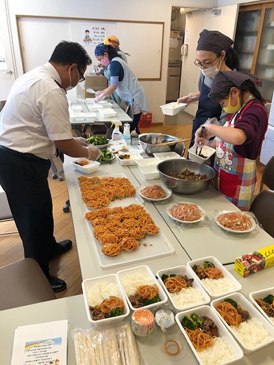 Salvation Army personnel prepare meals for children in Japan