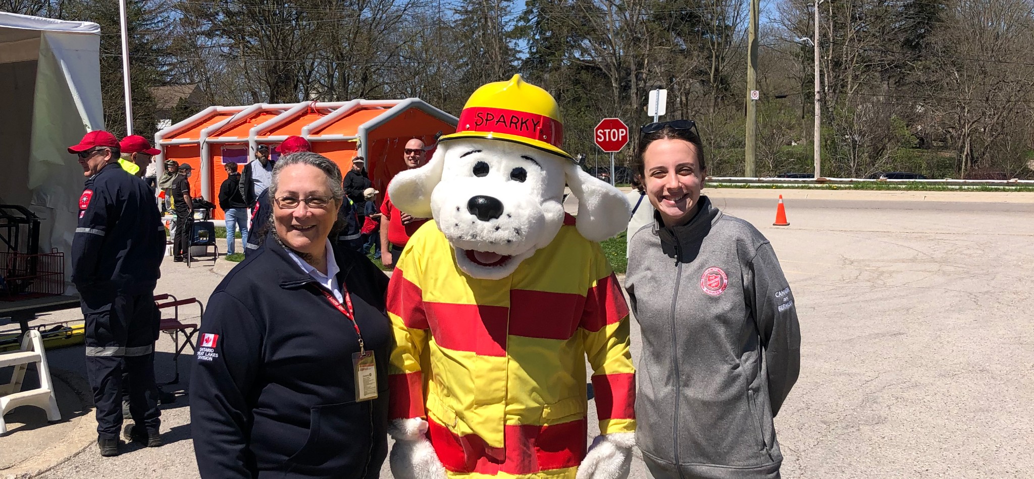 Two TSA workers posing with Sparky for EP Week