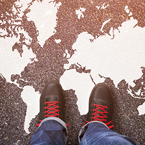 Image of someone standing on top of a floor with an image of a world map