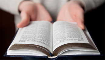 A person looking at a bible.