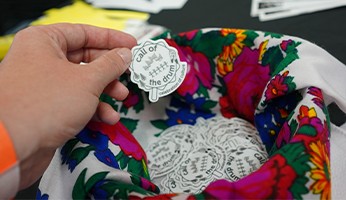 Image of a person's hand holding a sticker