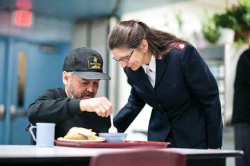 Mjr Karen Hoeft talks to a client in Winnipeg (Photo: Scott Streble)
