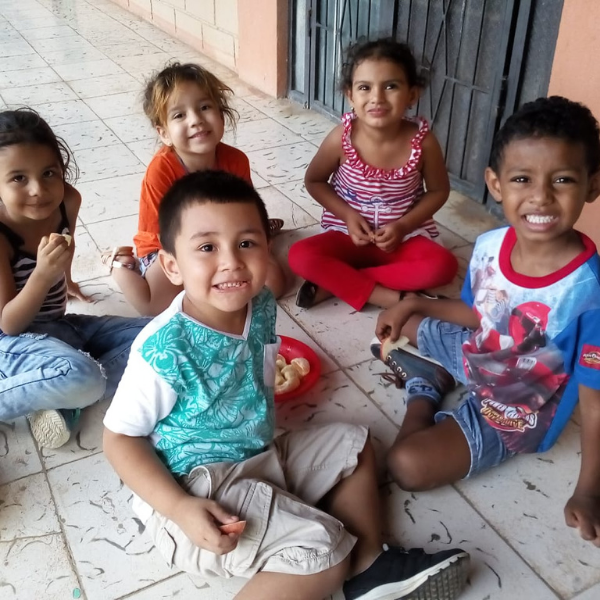 Children smiling while eating lunch at Santa Cruz Daycare in Costa Rica